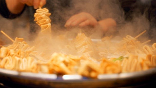 Steaming fish cake skewers in a pot
