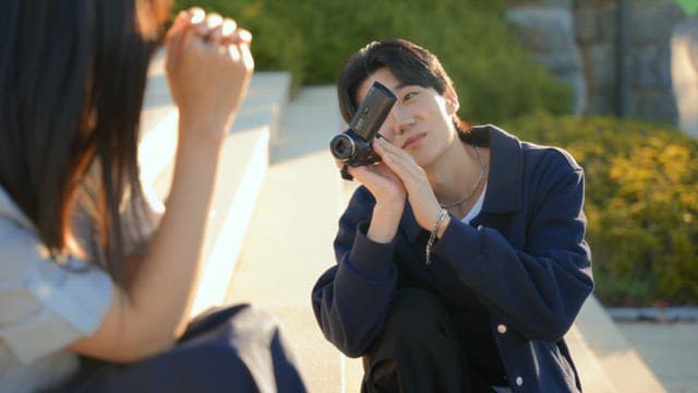 Couple filming a video with a camcorder in the park