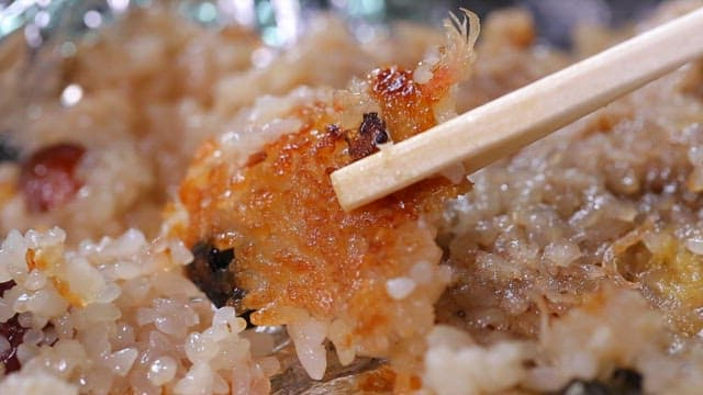 Chopsticks holding crispy rice