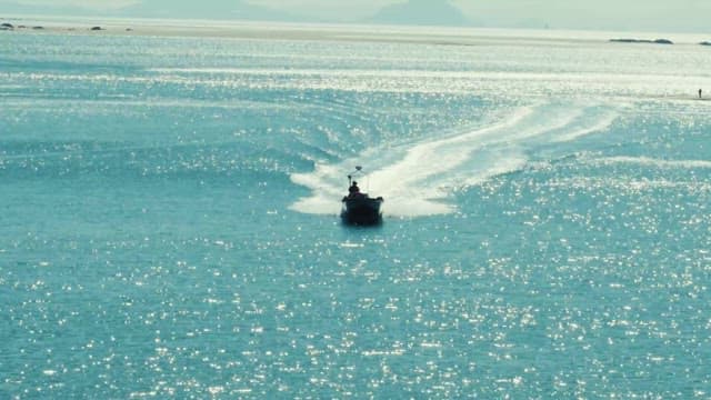Speedboat Gliding Across Sparkling Waters
