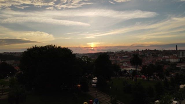 Sunset Over an Urban Riverside City with Red Roof Bildings