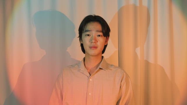 Man smiling in colorful lighting