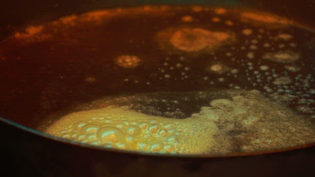 Cooking an omelet with carrots and green onions in a hot frying pan