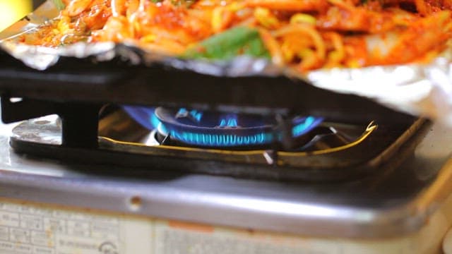 Cow skin salad cooking on a stove
