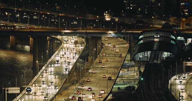 Illuminated Highway and Cityscape at Night