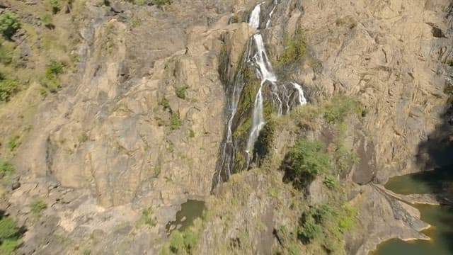 Aerial view of a cascading Barron Falls on a rocky cliff