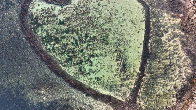 Heart-shaped rock formation by the sea