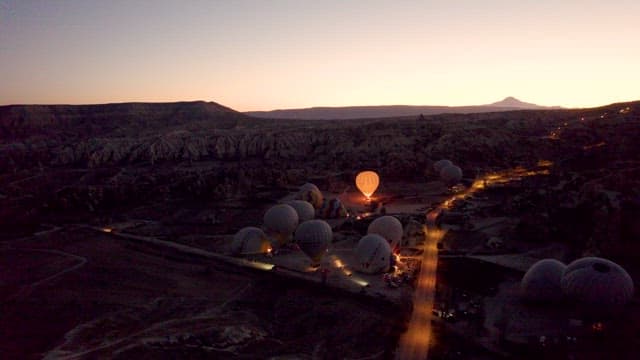Hot Air Balloon on a Field Surrounded by Rocky Terrain