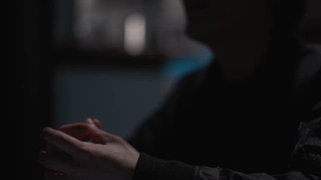 Silhouette of a Man Talking in a Dark Office