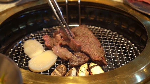 Grilled Meats Cooking on a Charcoal Grill