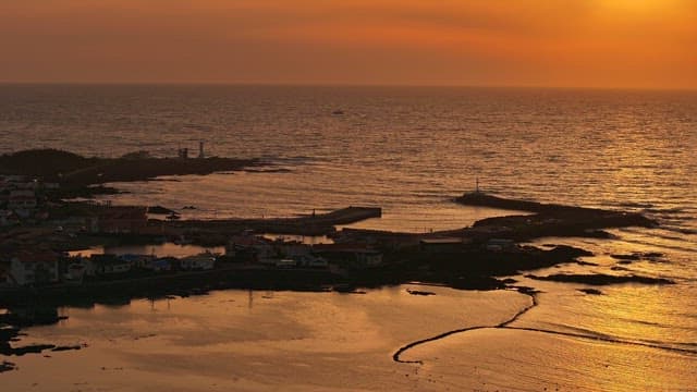 Sunset over a coastal village and sea