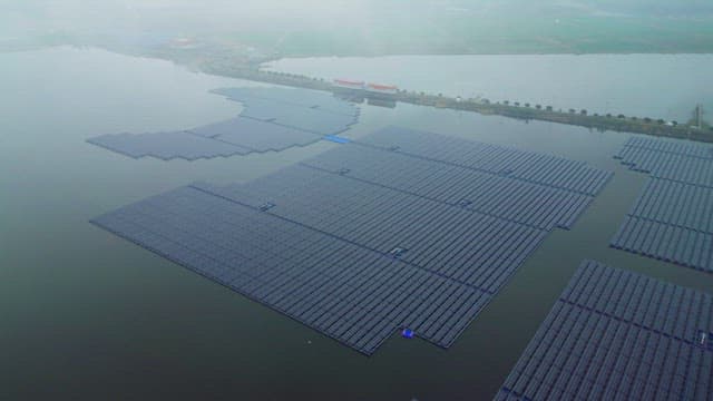 Floating solar panels on a misty river