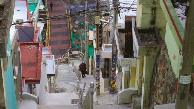 Person going up stairs at steep alley in residential area