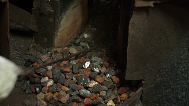 Coal being shoveled in a furnace