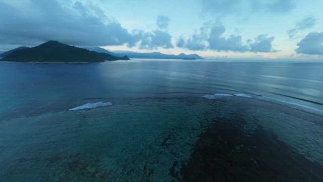 Quiet beach with gentle waves crashing at dawn