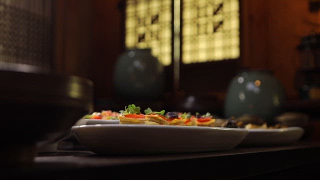 Variety of colorful dishes arranged beautifully on a table in a korean traditional setting