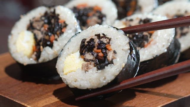One chopstick of kimbap with hijiki
