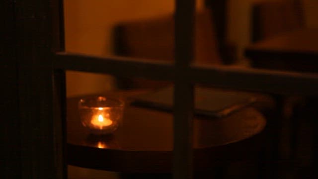 Cozy Room with Small Candles Lit Beyond the Window