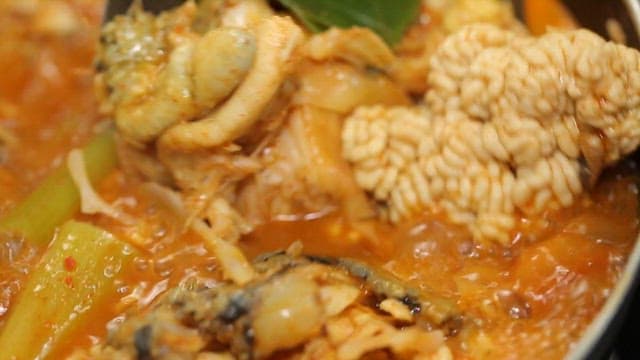 Spicy shaggy sea raven stew boiling in a pot