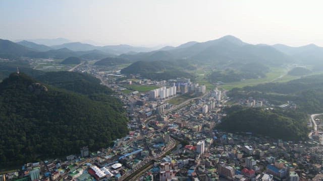 City surrounded by lush green mountains