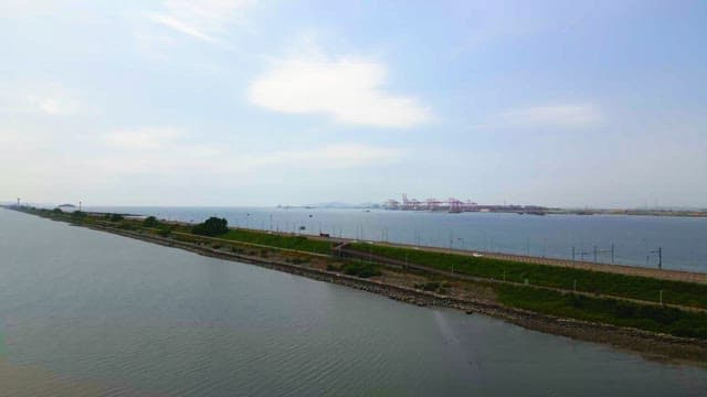 Long coastal road with cars driving