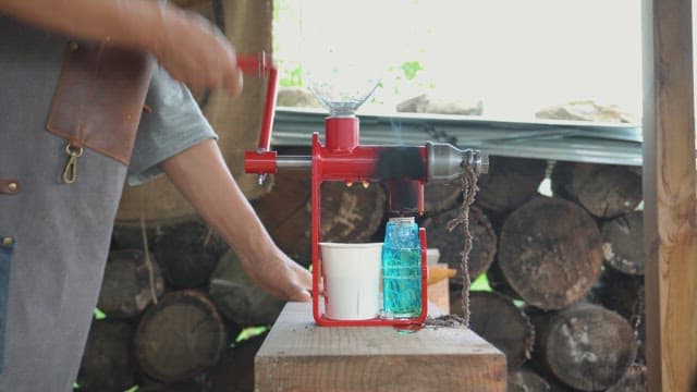 Hand pressing oil from seeds using a machine