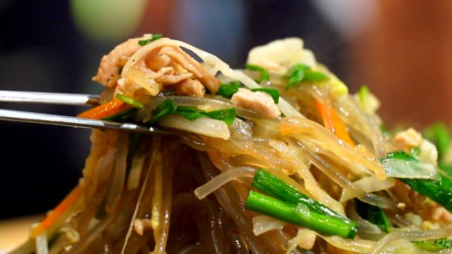 Chopsticks holding Korean japchae