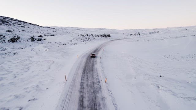 Car driving on a snowy mountain road