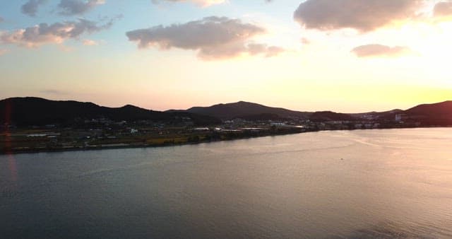 Sunset over a tranquil sea and hills
