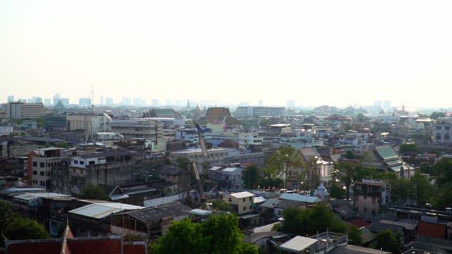 Wide cityscape of Bangkok under the midday sun