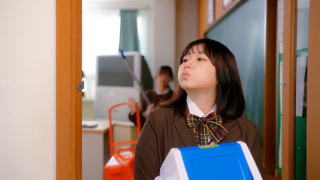 Students going out into the hallway carrying cleaning tools