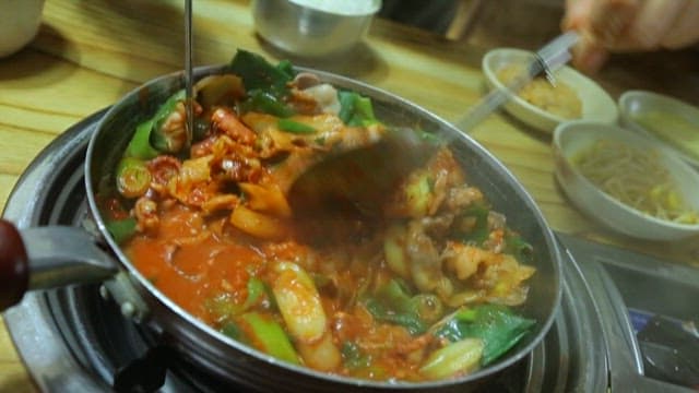 Food with octopus and meat in spicy seasoning