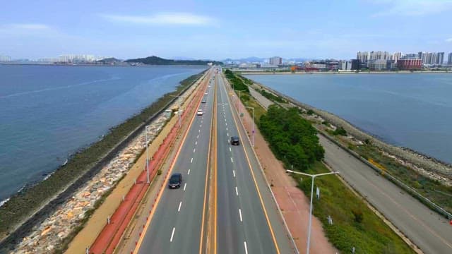 Highway by the sea with city skyline