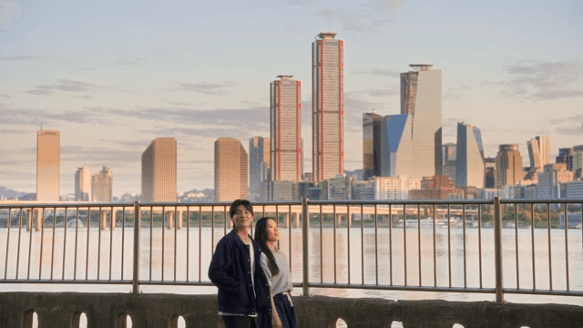 Couple walking by the river with cityscape