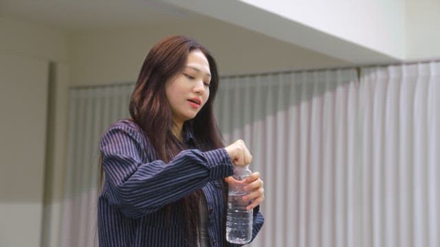 Woman drinking water indoors