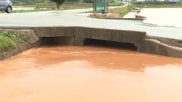 Flooded urban canal with muddy water