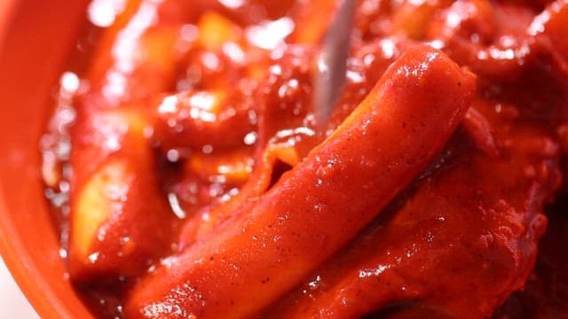 Spicy tteokbokk eaten with a fork