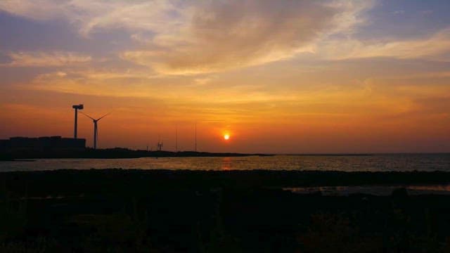 Sunset Over Coast and Wind Turbines