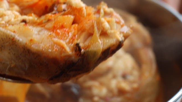 Appetizing piece of fish in a hot spicy stew