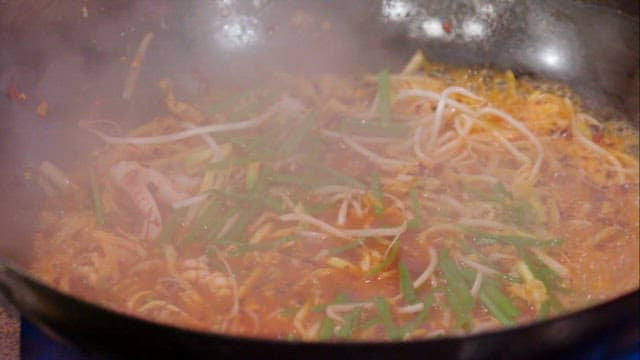 Stir-frying in a flaming wok at high heat
