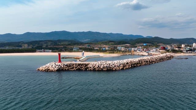 Lighthouse on a breakwater by the sea