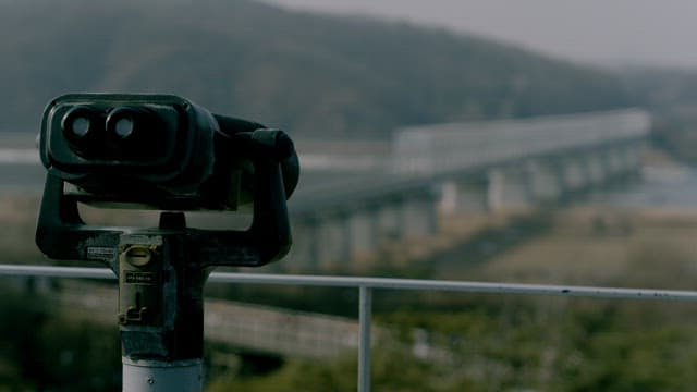 Coin-Operated Telescope Overlooking a Bridge and River