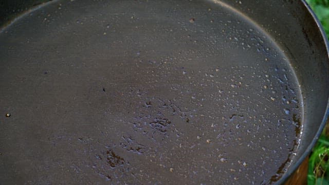 Grilling of juicy marinated pork on a hot frying pan