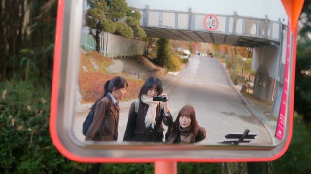 Three friends taking a selfie in a mirror