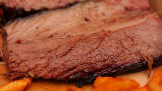Juicy slices of smoked brisket on a plate