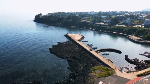 Coastal pier with boats and clear water