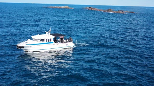 Speedboat cruising in the open blue sea