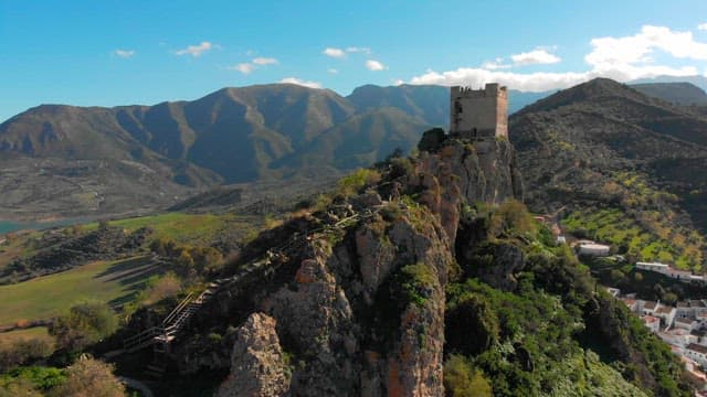 Castle on a rocky hill with mountain views