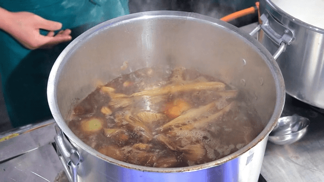 Boiled pork slices boiling in a pot