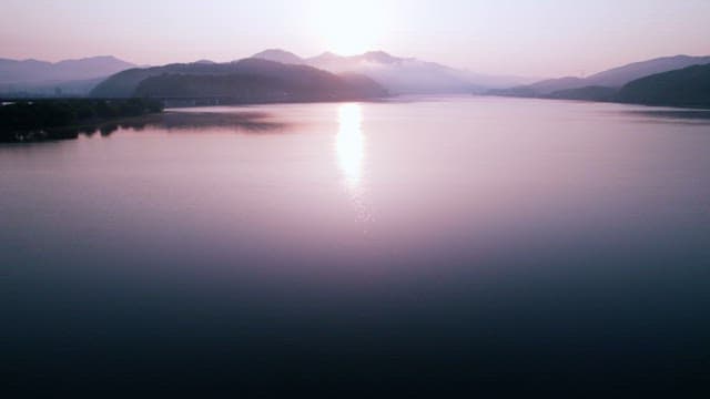 Sunrise Over a Serene Lake with Mountains